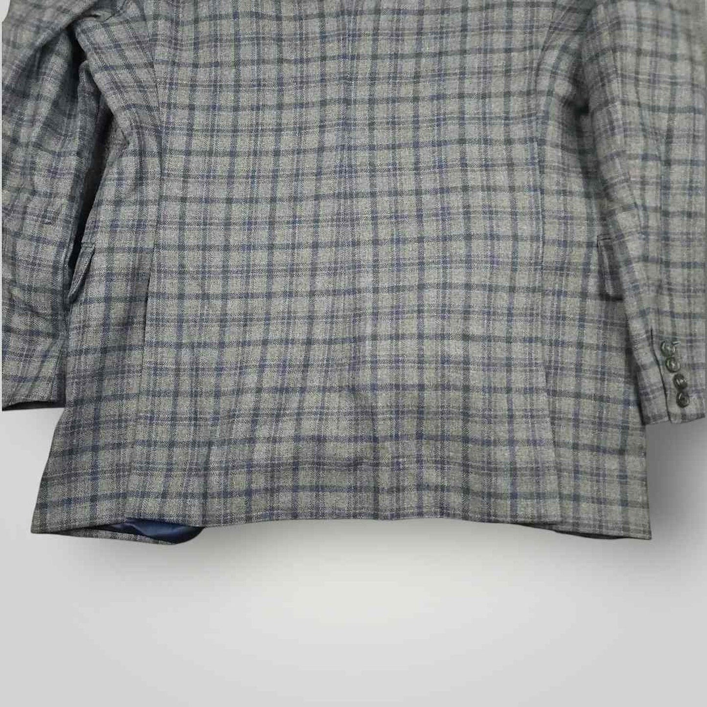 Lower rear view of Tom James Innocenti wool plaid sport coat highlighting vent construction and drape.