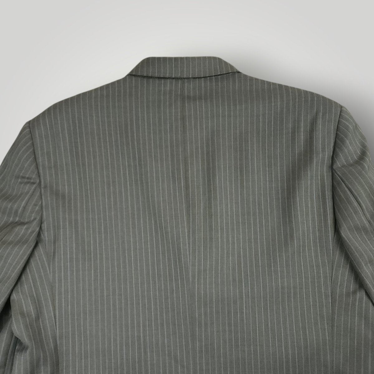 Rear jacket shoulder detail showing gray pinstripe pattern and tailoring