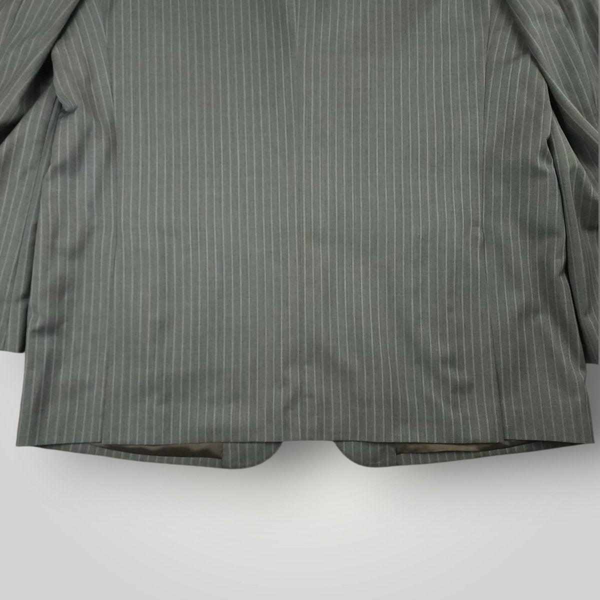 Rear lower jacket detail showing gray pinstripe pattern and tailoring