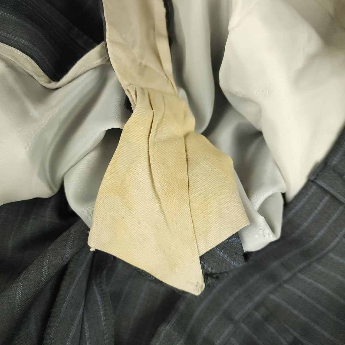 Minor wear and condition detail inside suit trousers waistband