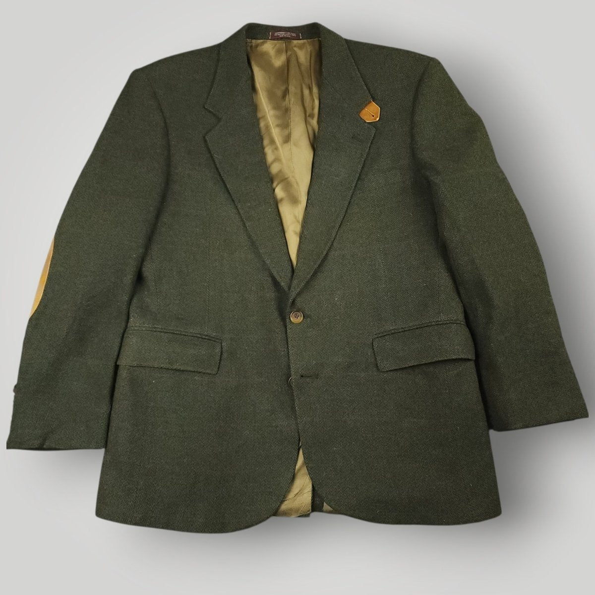 Front view of olive tweed sport coat with elbow patches and traditional country styling