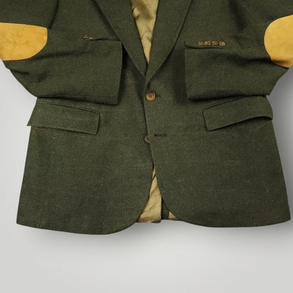 Close up of flap pockets button stance and elbow patches on olive tweed blazer