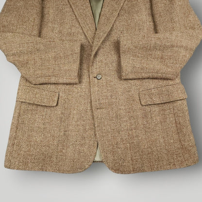 Close up of flap pockets and herringbone wool fabric on Harris Tweed blazer
