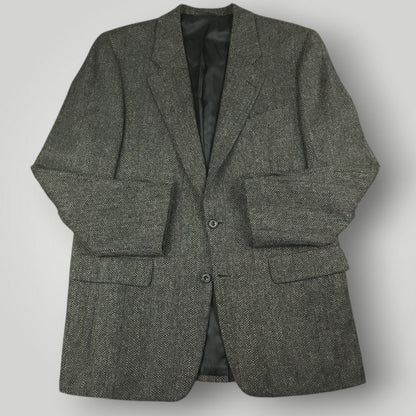 Gray herringbone tweed jacket with notched lapels and flap pockets