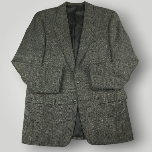 Gray herringbone tweed jacket with notched lapels and flap pockets