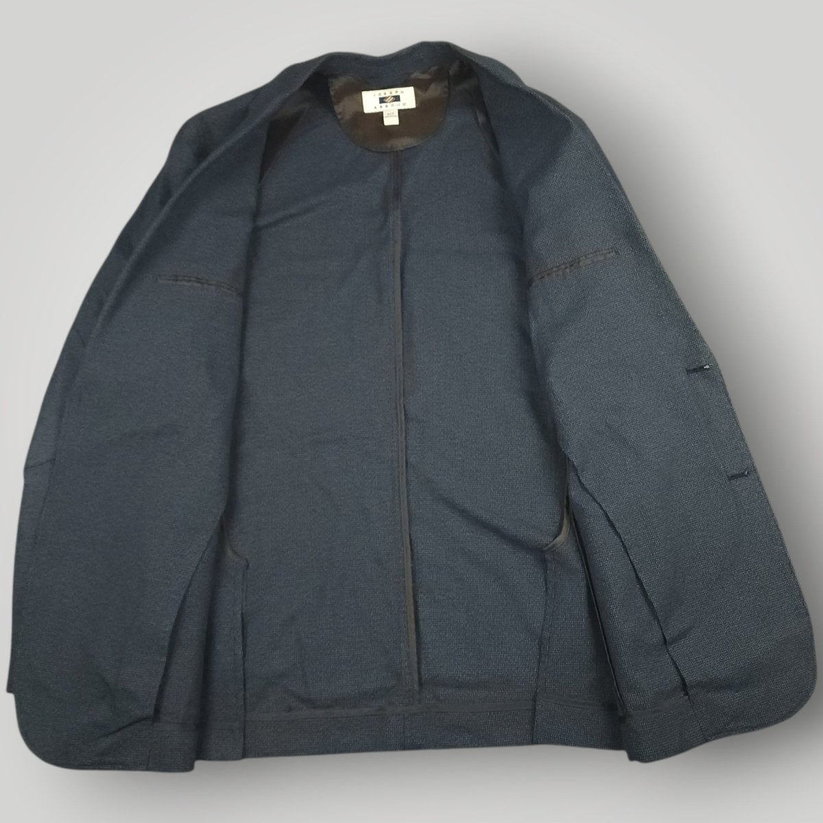 Interior view of Joseph Abboud blue sport coat showing lining and inside label