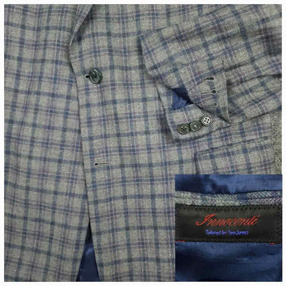 Tom James Innocenti Italian wool plaid sport coat fabric detail showing blue-gray tartan pattern and Innocenti label.