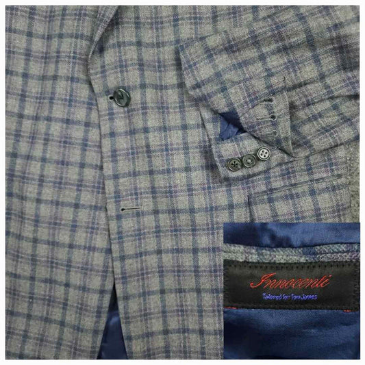 Tom James Innocenti Italian wool plaid sport coat fabric detail showing blue-gray tartan pattern and Innocenti label.