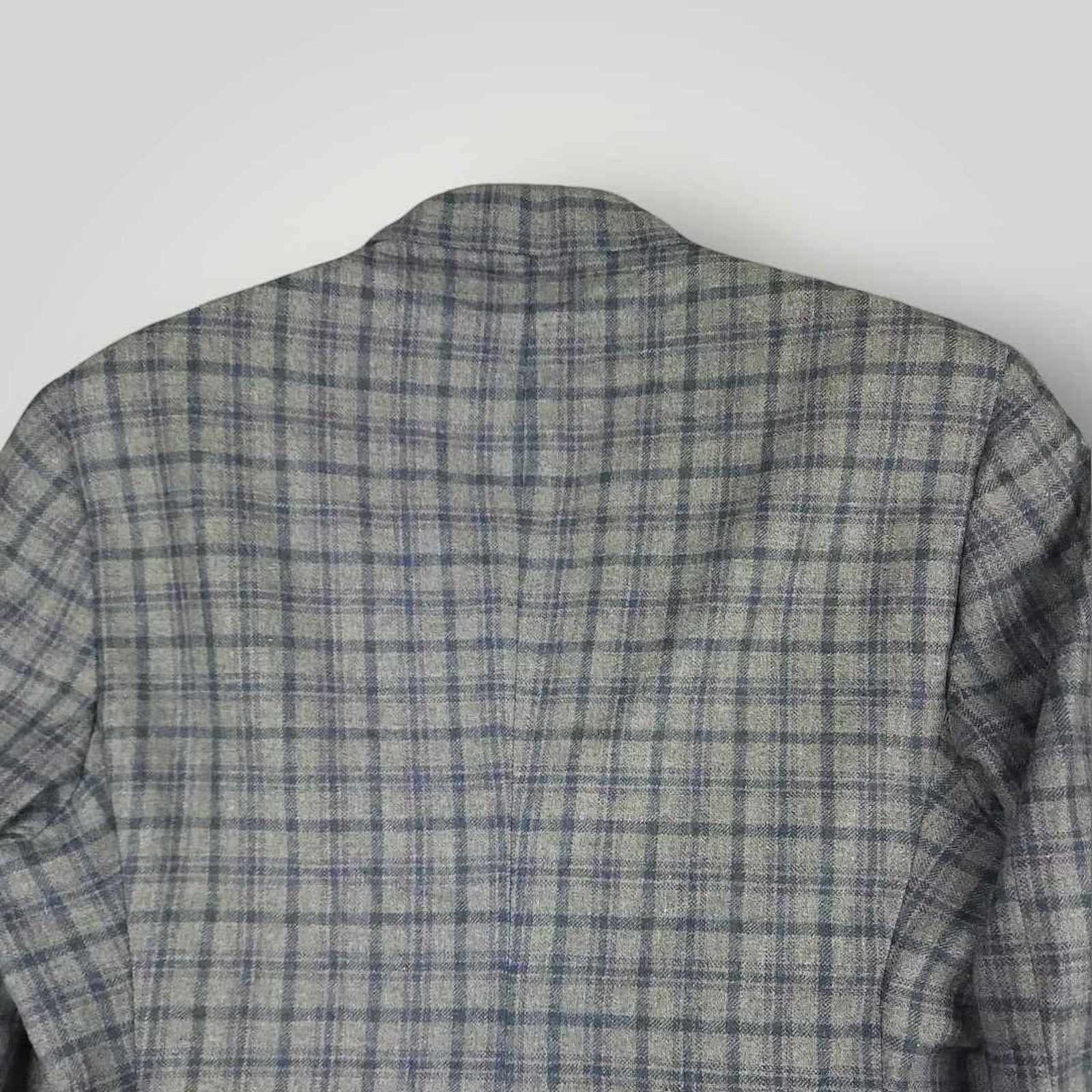 Upper back detail of Tom James Innocenti plaid sack jacket showing pattern alignment and tailoring.
