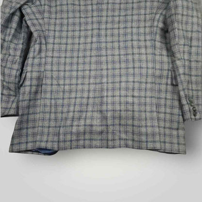 Lower rear view of Tom James Innocenti wool plaid sport coat highlighting vent construction and drape.