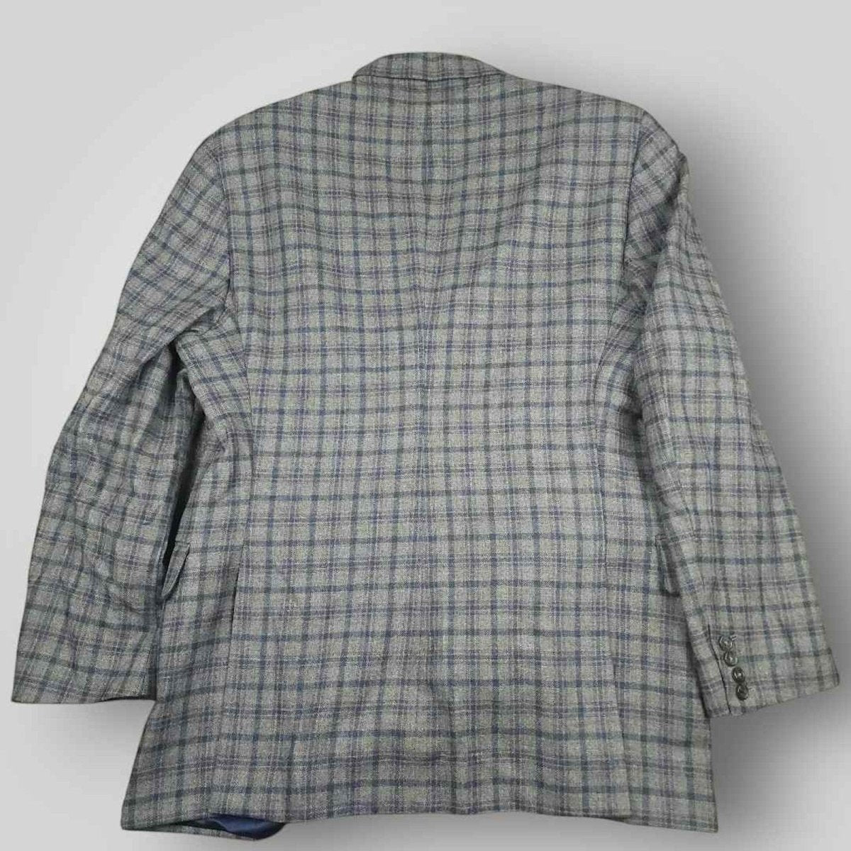 Rear view of Tom James Innocenti Italian wool plaid sport coat showing classic tailored construction.