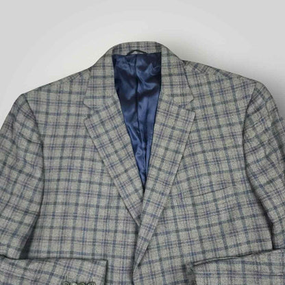 Open front view of Tom James Innocenti plaid wool sport coat displaying blue lining and interior craftsmanship.
