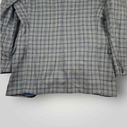 Lower rear view of Tom James Innocenti wool plaid sport coat highlighting vent construction and drape.