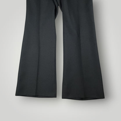 Flared, bell bottom leg opening detail on vintage wool suit trousers