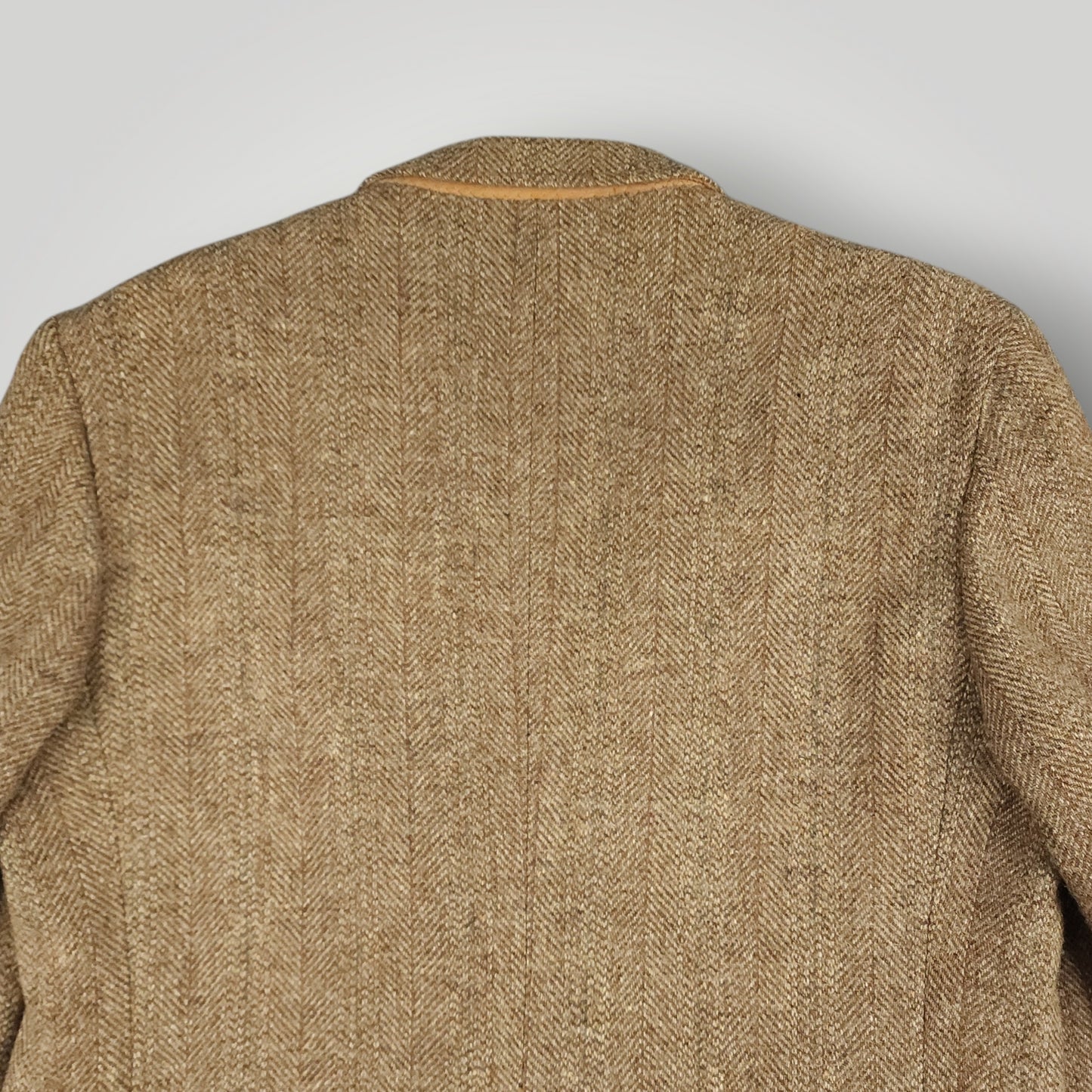 Rear shoulder detail showing texture of brown Harris Tweed wool fabric