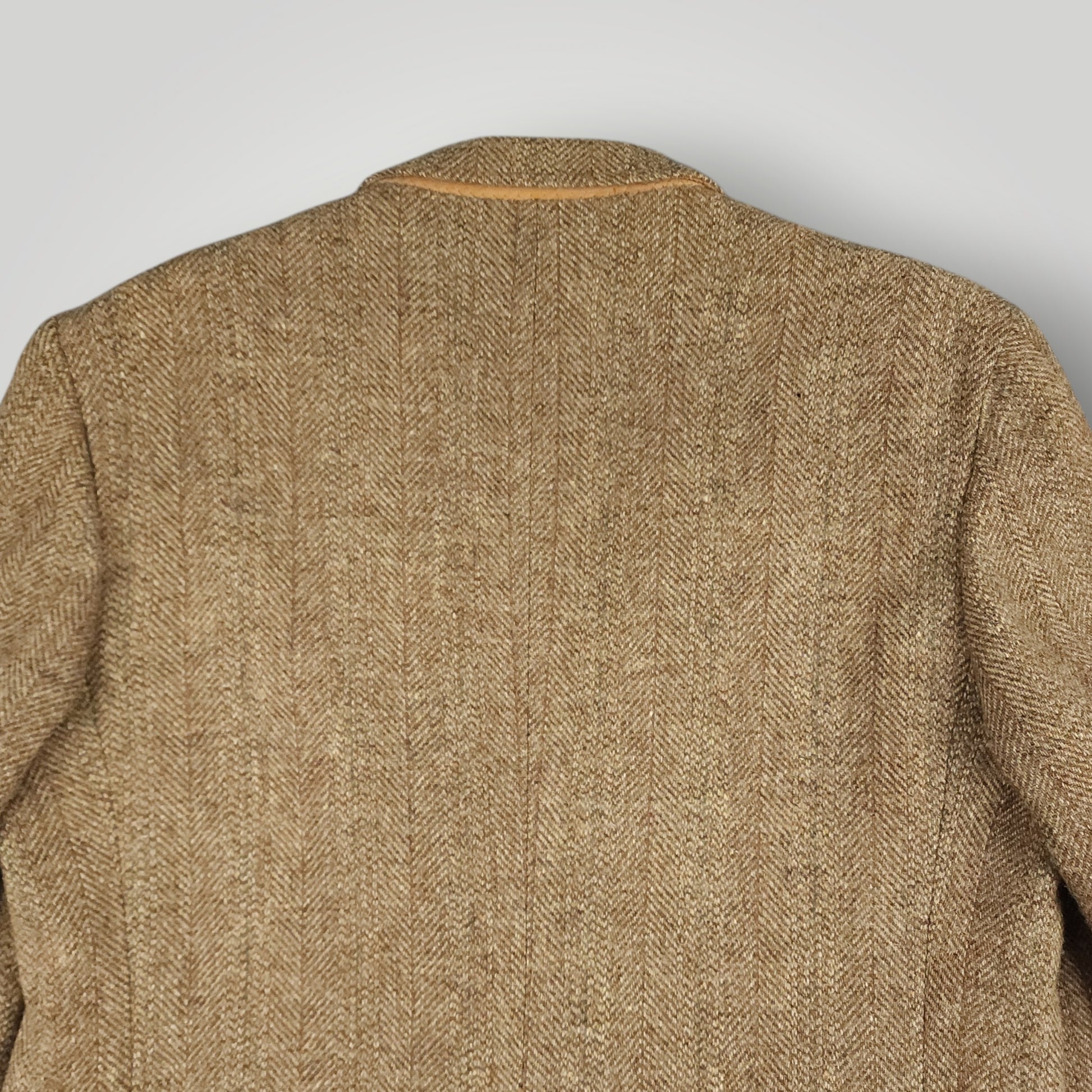 Rear shoulder detail showing texture of brown Harris Tweed wool fabric