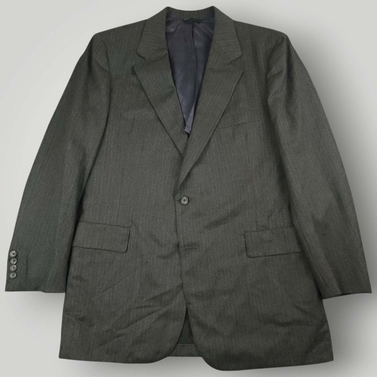 A dark gray pinstripe suit jacket with a two-button closure, displayed flat against a light gray background.